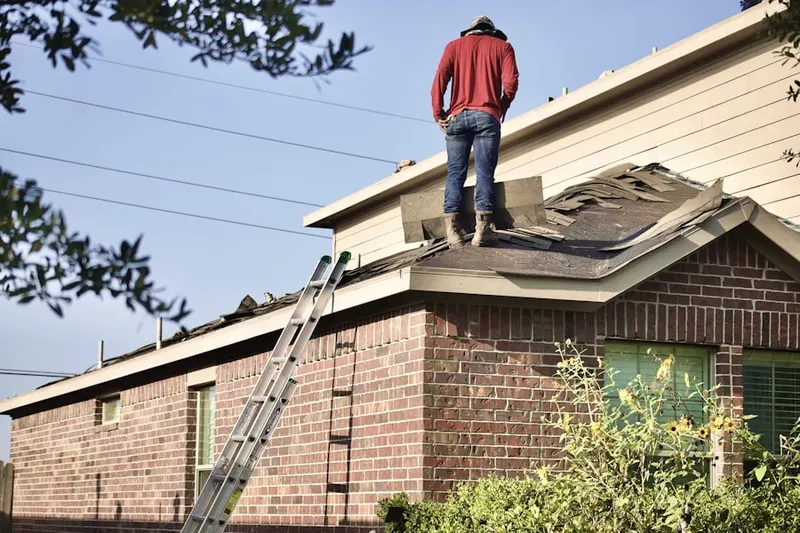 Professional roofer working on a residential roof in Bay Park Estates